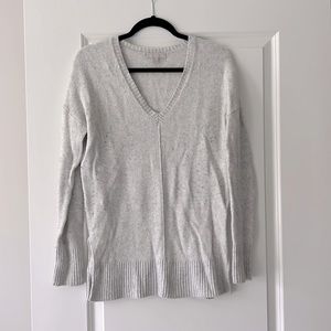 V-neck light gray sweater with split side